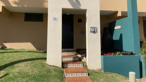A building entrance with a tiled pathway leading to a door marked 'E6'. - NEW! Walking distance to Boqueron ‘Poblado’, townhouse w/amazing views, sleeps 8 (Boqueron)