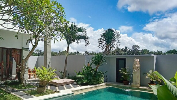 A swimming pool with a clear blue water, surrounded by potted plants and a statue. - Just outside Ubud, peaceful 3BR Villa with rice field views. (Tampaksiring, Gianyar Regency)