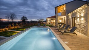 A modern house with a swimming pool, outdoor seating, and a stone exterior. - Oasis of peace, with wellness, playground, pool, barbecue (Mofardini)