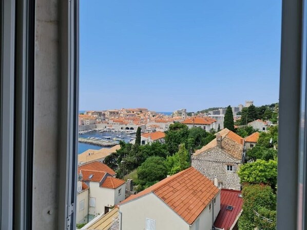 A coastal town with historic buildings and a marina. - *Apartment Primavera with stunning views of Old Town and sea (Dubrovnik)