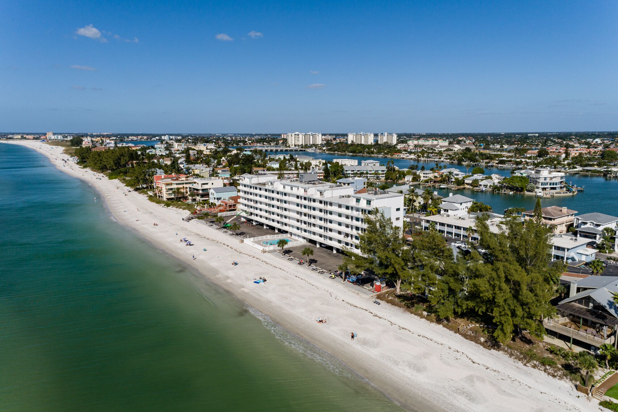 A coastal hotel with multiple floors, a beachside location, and a marina.