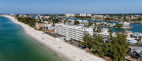 A coastal hotel with multiple floors, a beachside location, and a marina.