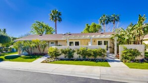 A two-story house with a front porch, a driveway, and a well-maintained lawn. - The Villas at Emerald Desert RV Resort (Palm Desert)