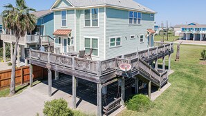 A two-story house with a deck and a covered porch.