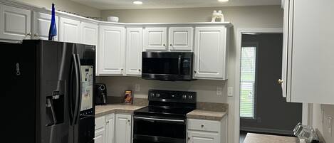 Fridge, stovetop, dishwasher, coffee/tea maker