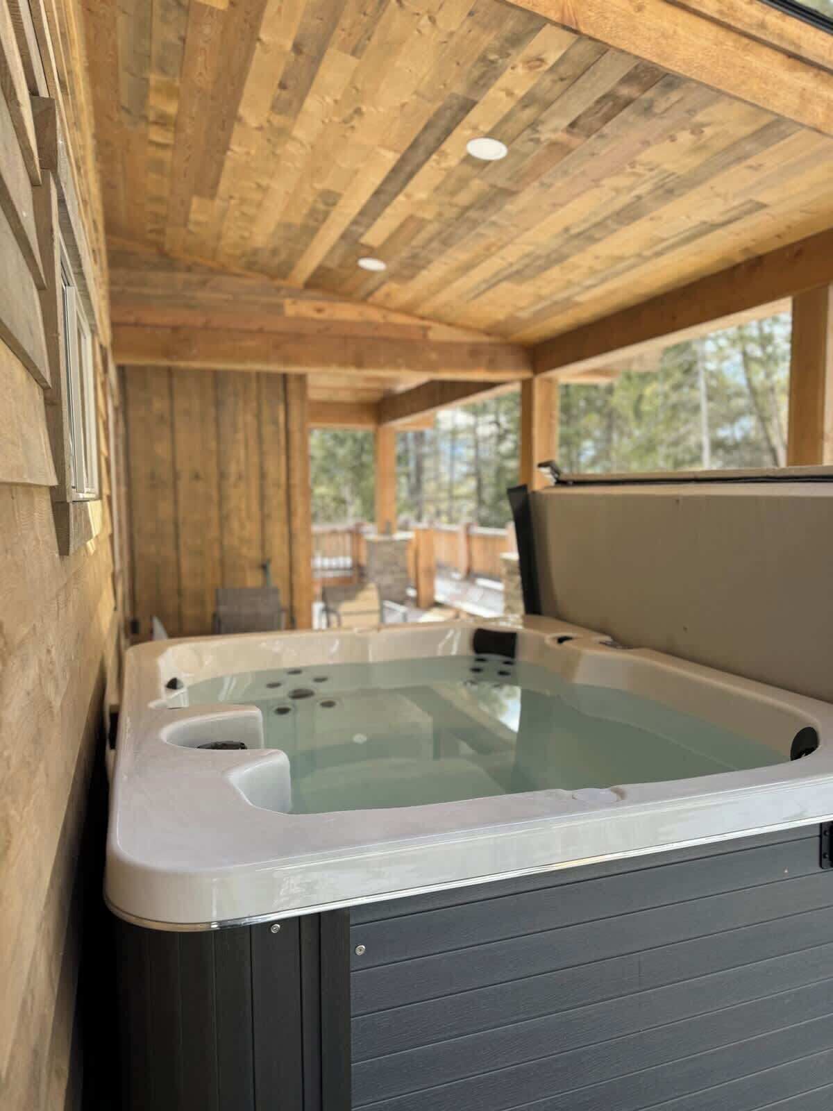 A wooden cabin with a hot tub.