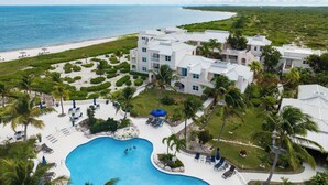A resort with a swimming pool, beach access, and multiple buildings with balconies. - Beautiful 2 bed/2 bath Ocean view  - TripAdvisor winner 2016,2017,2018 and 2019! (Wheeland Settlement)