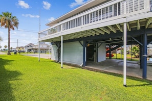 A two-story building with a covered porch and a garage.