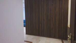 A room with a sliding door, a tiled floor, and a visible blue sofa in the background. - Ravishing Studio (Casablanca)