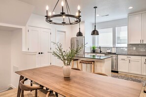 Enjoy cooking in this well-equipped kitchen with a central island, oven, and stainless steel refrigerator.