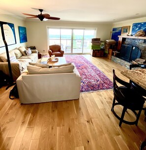 Relax in this inviting living room with a sofa, coffee table, and dining area.