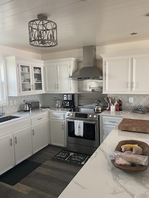 Enjoy cooking in this well-equipped kitchen with an oven, coffee maker, and kettle.
