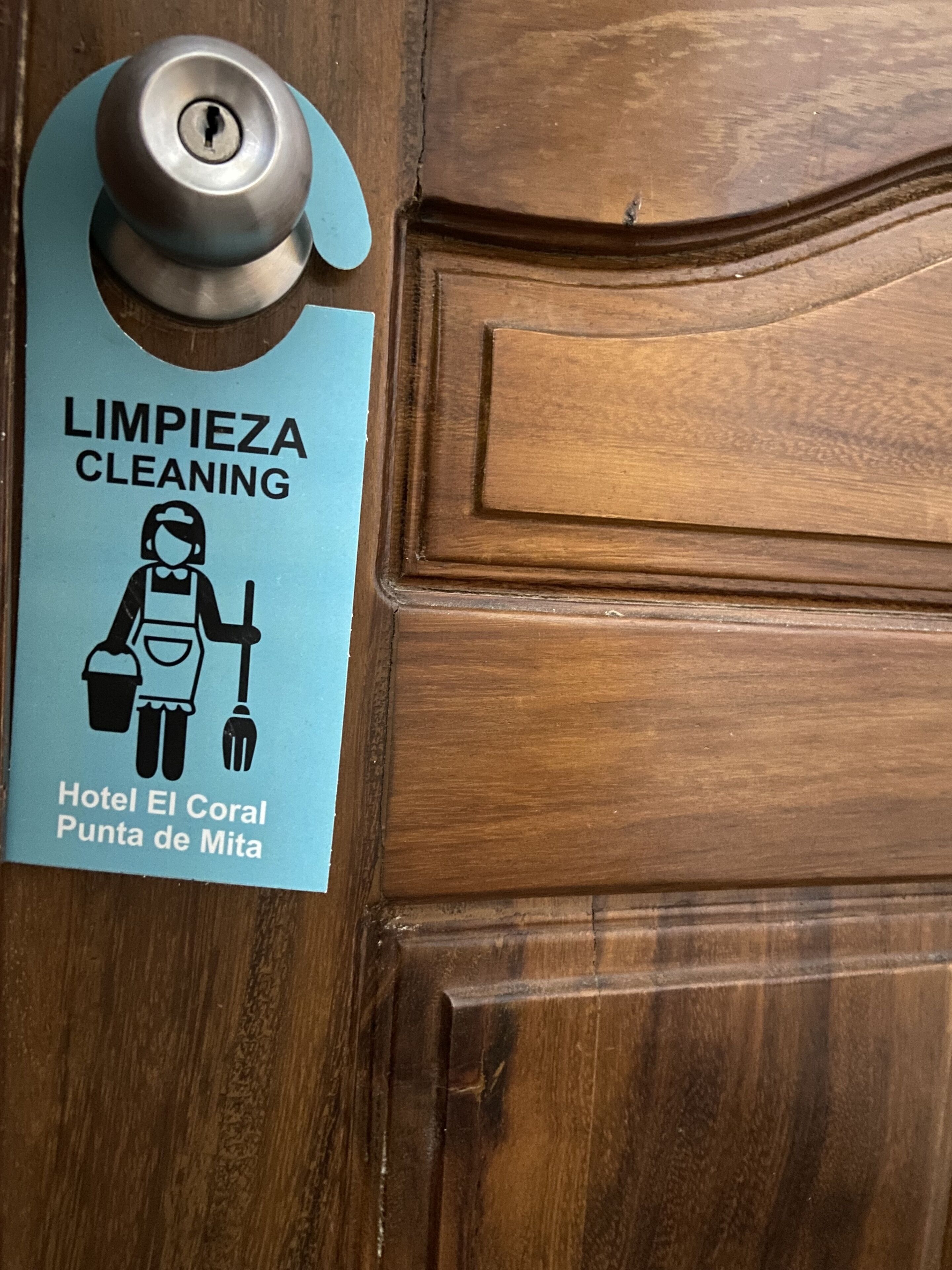 A door with a cleaning sign and a keyhole.