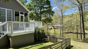 A house with a wooden deck and a fenced yard. - Peaceful Mountain Home: backs to a private fishing pond on two acres (Pickens)