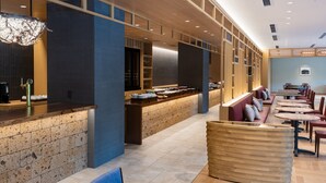 A modern restaurant with a long counter, seating area, and a decorative ceiling. - Mitsui Garden Hotel Kashiwanoha Park Side Chiba  (Kashiwa)