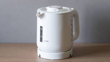A white electric kettle with a digital display and a lid.