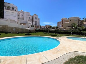 Relax by the large pool surrounded by lush greenery and beautifully manicured grounds.