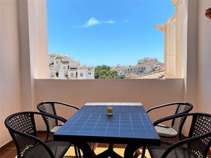 Enjoy a refreshing drink on the balcony with a view of the coastal town.
