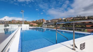 Seasonal outdoor pool, open 11:00 AM to 9:00 PM, pool loungers