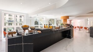 A modern kitchen with a black marble island, large windows, and a view of the city. - Ikonik Gran Via (Madrid)
