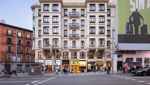 A multi-story building with a classical architectural style, featuring balconies and large windows. - Ikonik Gran Via (Madrid)