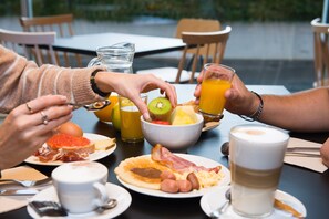 A breakfast setting with various food items and beverages on a table. - Ibis Styles Santander  (Santander)