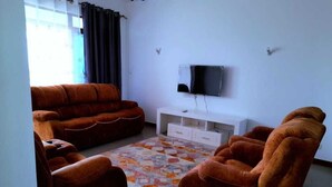 Luxury Apartment | Living area | 14-inch Smart TV with digital channels, TV - Stay.Plus sultan Palace Penthouse (Mtwapa)