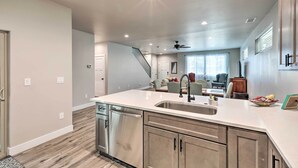 A modern kitchen with stainless steel appliances, a large island, and a view to the living area. - Modern Flagstaff Home, 4 Mi to Downtown! (Flagstaff)