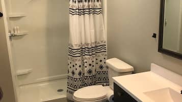 Shower, hair dryer, towels, toilet paper