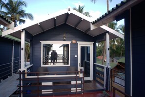 A blue building with a balcony and a door marked with the number 208. - Agonda Heritage (Canacona)