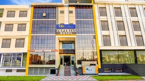 The exterior of the Imperial Hotel with a visible entrance, a checkered pathway leading to the entrance, and a sign for the adjacent restaurant. - Hotel Imperial Udaipur (Udaipur)