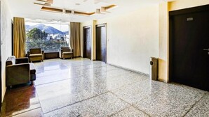 A spacious lobby with a polished floor, seating area, and a view of the outdoors. - Hotel Imperial Udaipur (Udaipur)