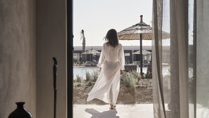 A room with a large window, a piano, and a view of a pool and outdoor area. - Casa Cook North Coast -  Adults only (El Alamein)