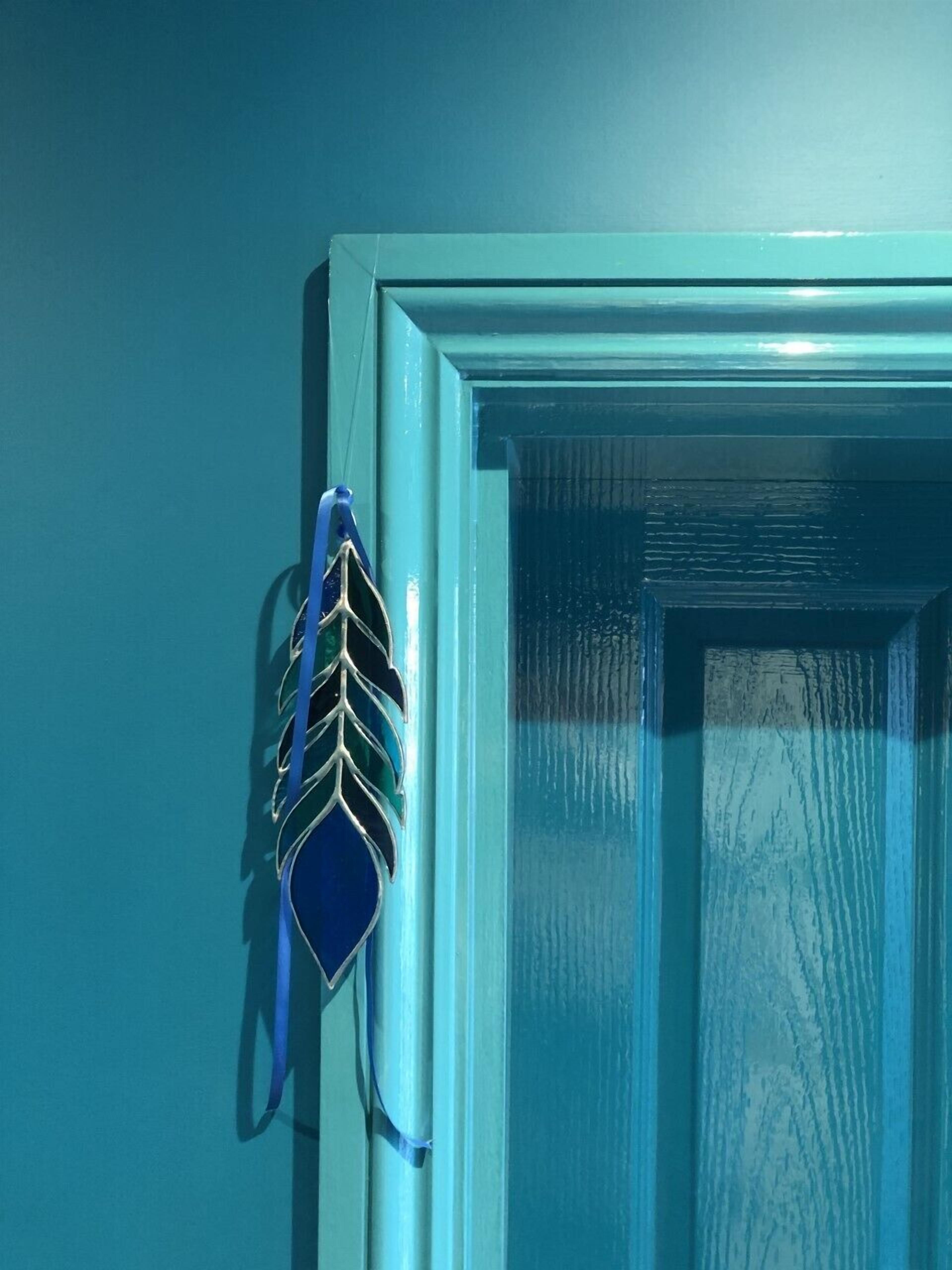 A door with a decorative metal piece and a textured glass panel.