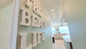 A hallway with a wall-mounted sign reading "THE BEACH LIFE".
