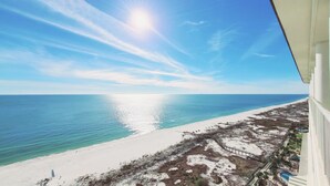 A beachfront property with a clear view of the ocean and a sandy beach.
