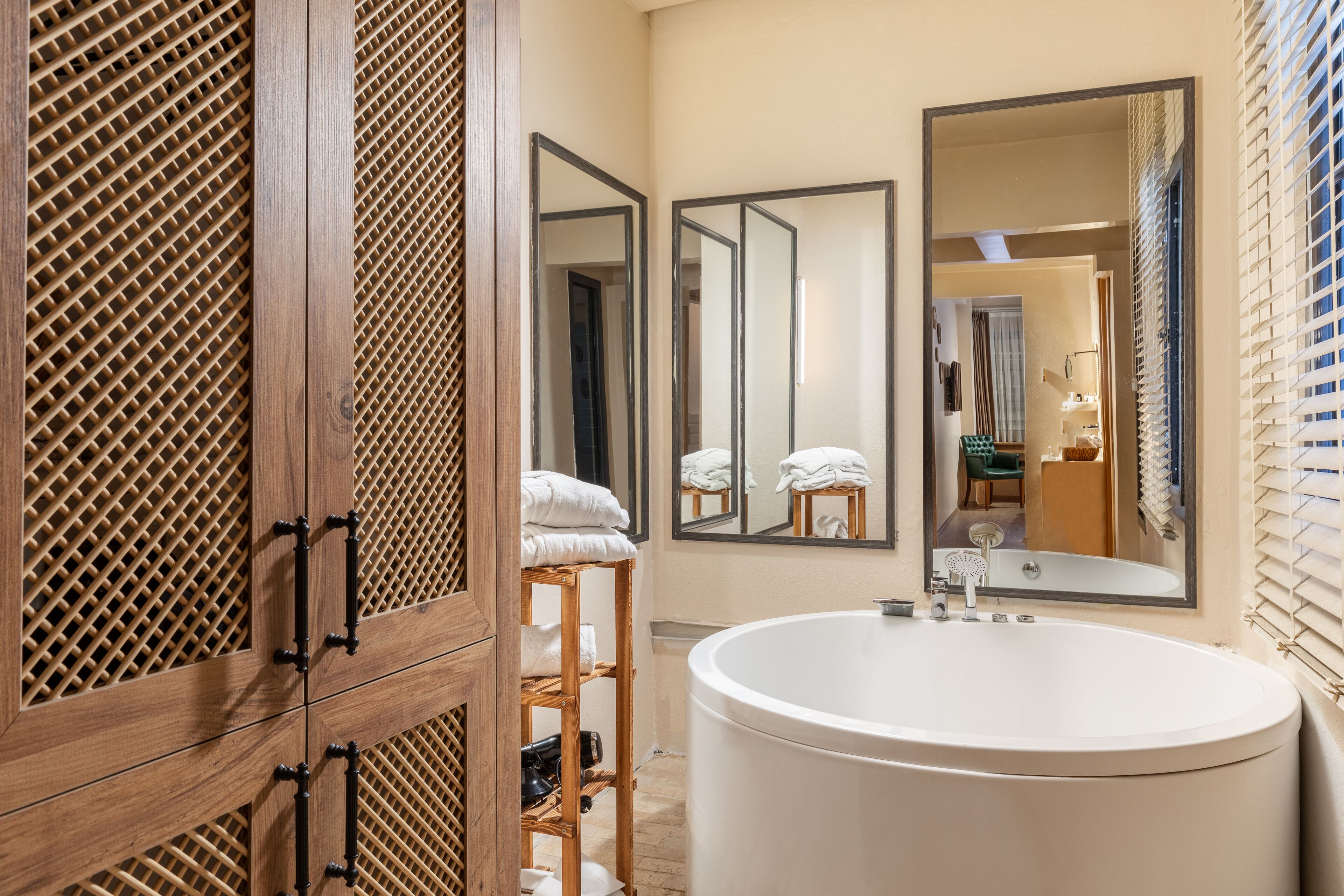 wellness spa suite | bathroom | designer toiletries, hair dryer, slippers, towels