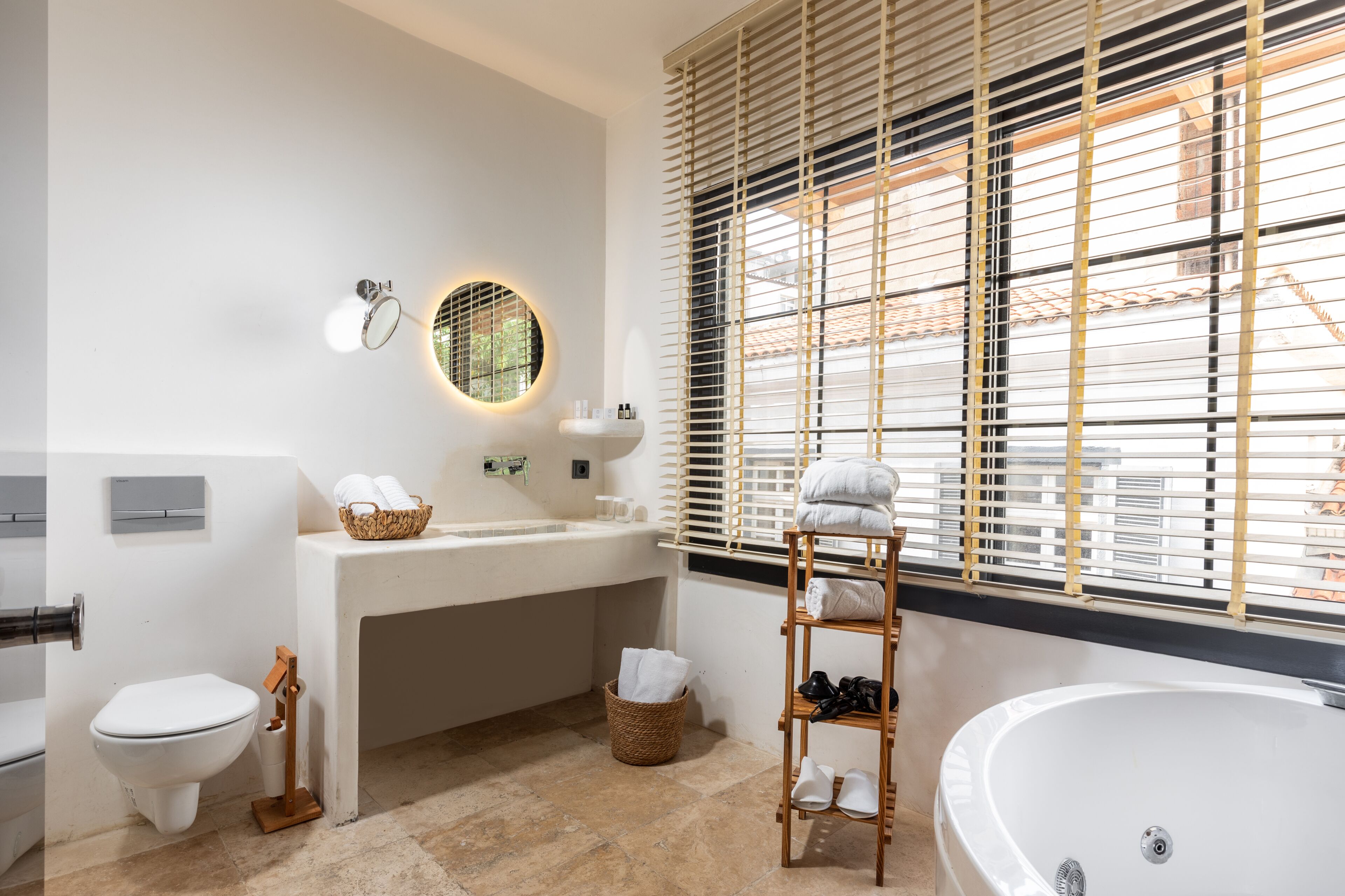 wellness spa suite | bathroom | designer toiletries, hair dryer, slippers, towels