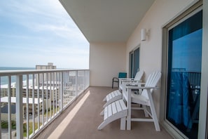Enjoy the ocean view from this room's balcony, featuring a table and chairs.