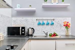 Fridge, microwave, stovetop, coffee/tea maker