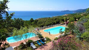 A pool area with two pools, surrounded by greenery and overlooking a coastal landscape. - Casa di Toro, facing the sea, rated 4 *, swimming pools, Palombaggia beaches 1.9KM. (Porto-Vecchio)