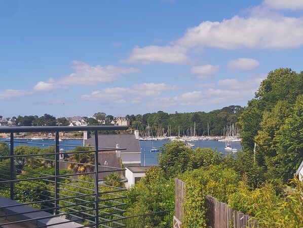 A marina with boats, a bridge, and residential buildings in the background.