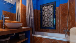 A bathroom with a white bathtub, a large white sink, and a toilet. - Casa Nora T2 (Castro Marim)