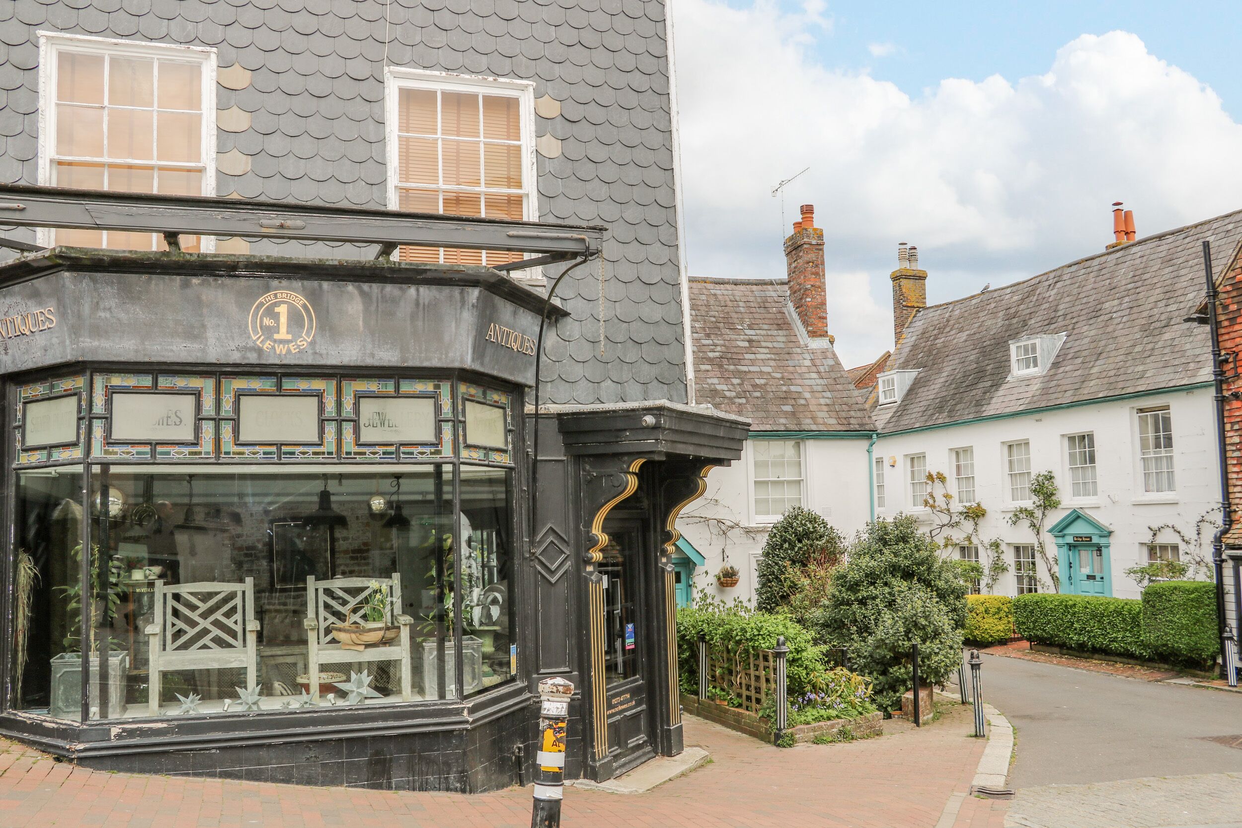 A corner building with a shop front labeled "Antiques No 1".