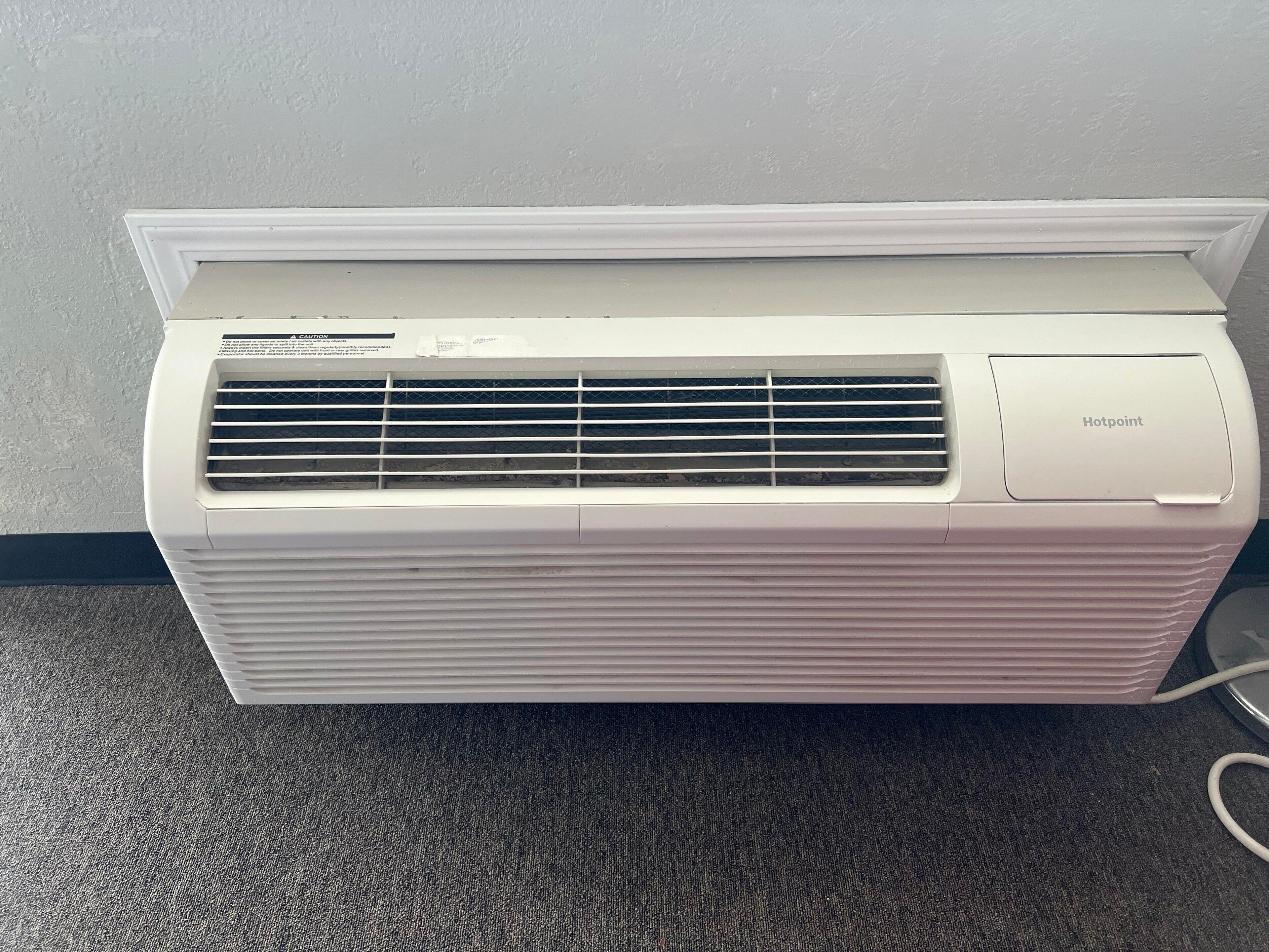 A white portable air conditioner with a front vent and a control panel on the right side.