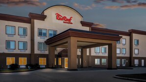Edificio de Red Roof Inn & Suites con vestíbulo cubierto y varias ventanas.