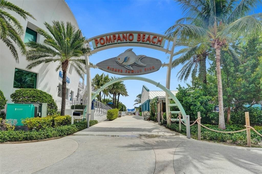 A sign for Pompano Beach with a fish symbol, indicating a beachfront location.