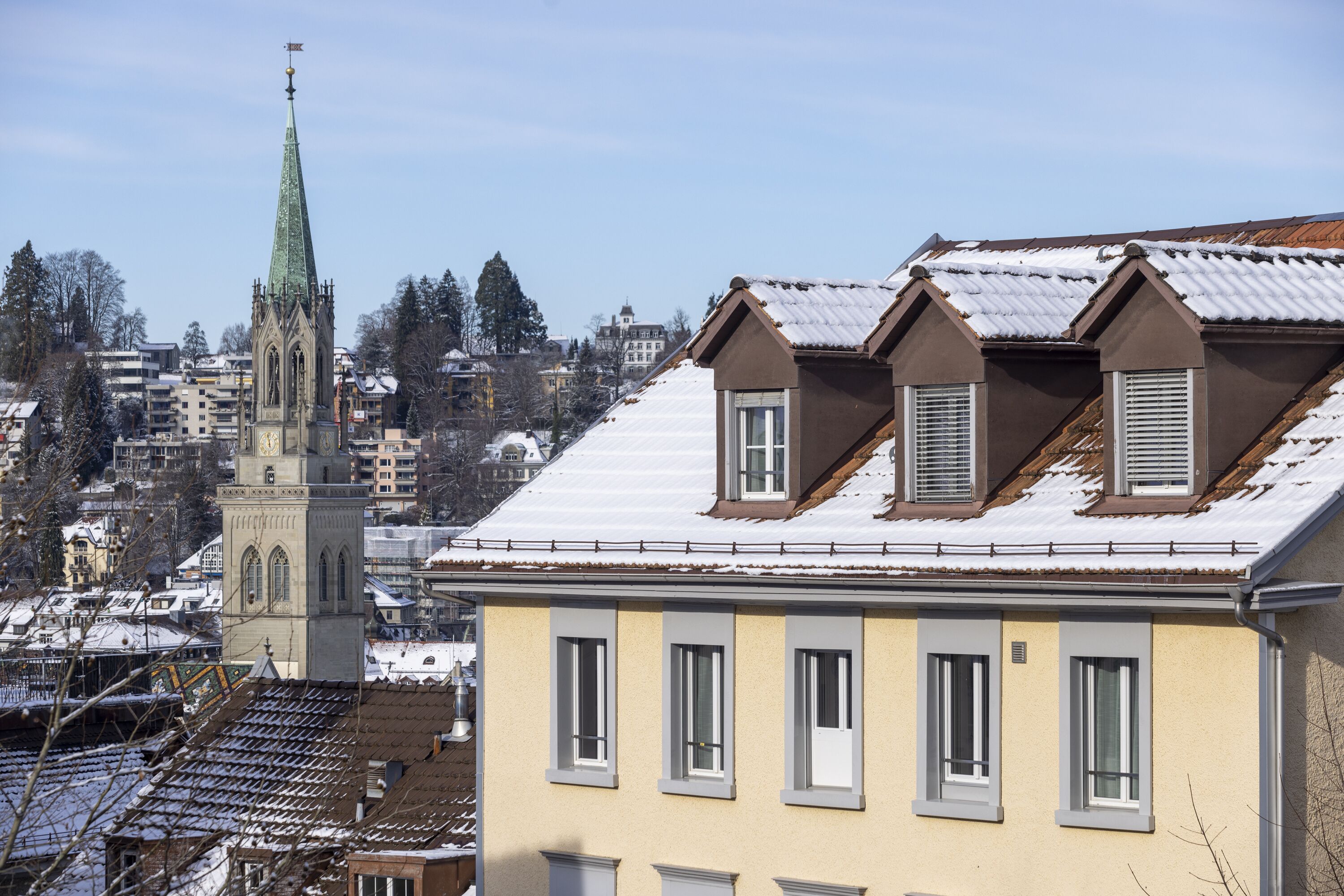 A building with multiple windows and a sloped roof, likely a residential or small commercial property.