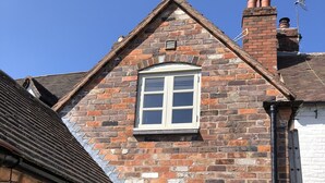 A brick house with a pitched roof, a chimney, and a small attached garage. - AWARD WINNING Shining Star on the Historic Cartway with River Views (Bridgnorth)