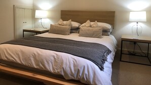 A bedroom with a bed, two bedside tables, a star decoration, and a lamp on each table. - AWARD WINNING Shining Star on the Historic Cartway with River Views (Bridgnorth)